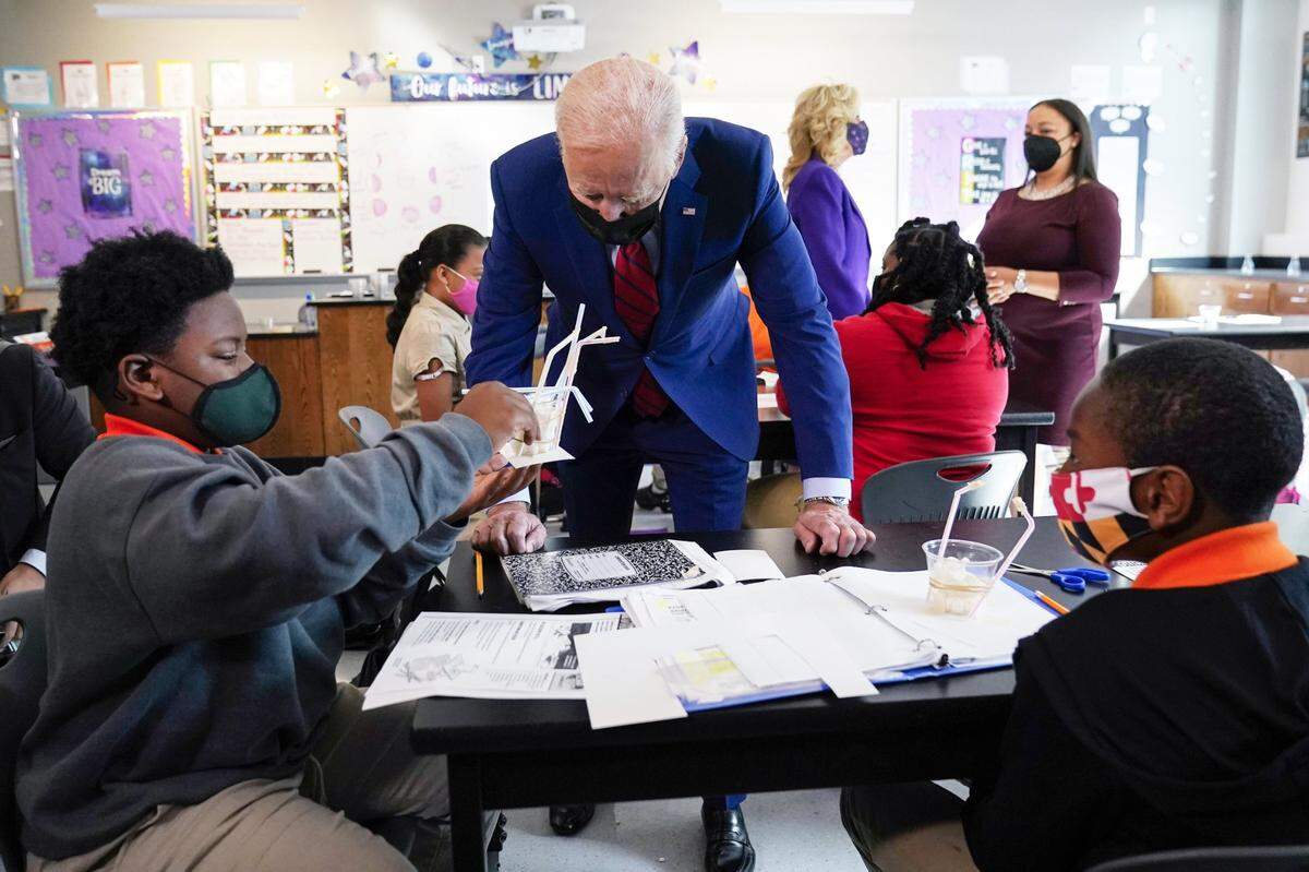 In this Sept. 10, 2021, photo President Joe Biden talks to students at Brookland Middle School in Washington. Biden’s Build Back Better plan, which is now in limbo, promised historic investments across all levels of education. The proposal includes universal prekindergarten and expanded child care subsidies, among others.
