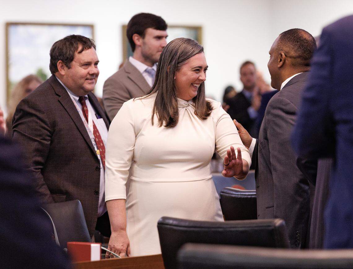 Democratic Rep. Amanda Cook greets colleagues at the start of the House session on Tuesday, April 21, 2026, at the Legislative Building in Raleigh, N.C.