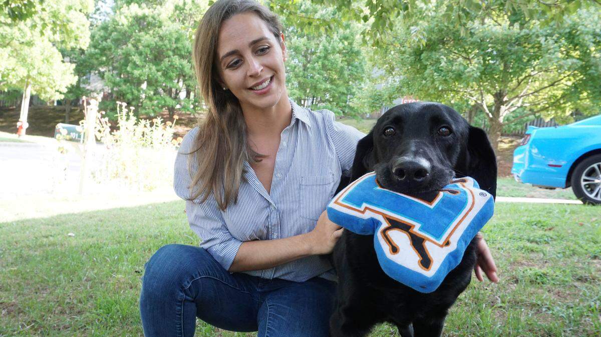 Sgt. Yeager and handler Caroline Zuendel photographed outside of their home in Cary on Aug. 23, 2019. Zuendel’s family adopted Yeager in 2012 after he recovered from shrapnel injuries.