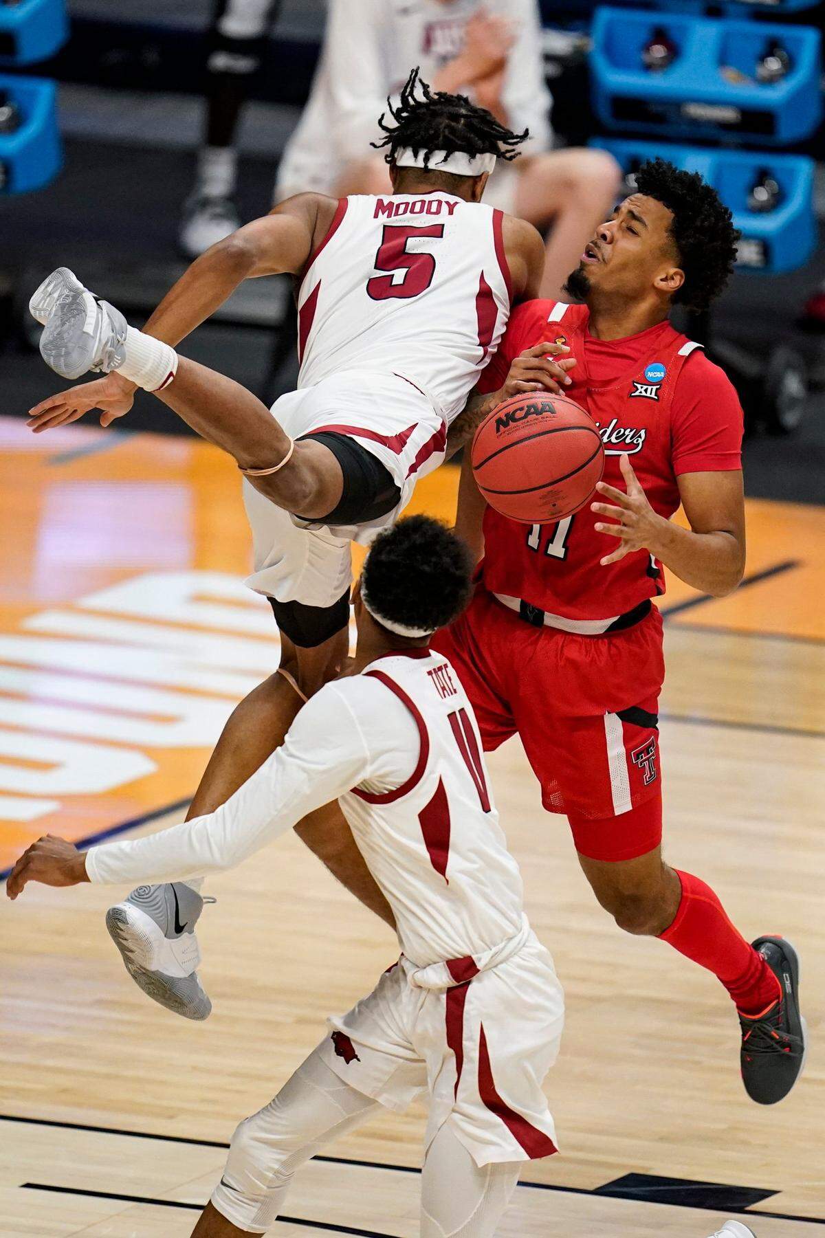 Arkansas guard Moses Moody (5) and Texas Tech guard Micah Peavy (5) collide in the first half of a second-round game in the NCAA men’s college basketball tournament at Hinkle Fieldhouse in Indianapolis, Sunday, March 21, 2021.
