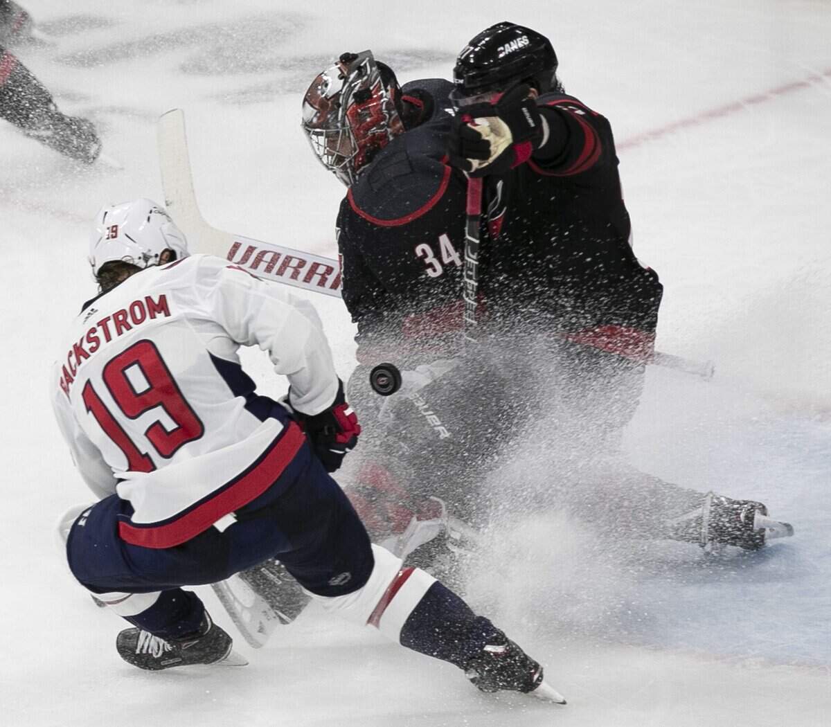 Carolina Hurricanes’ goalie Petr Mrazek (34) and Justin Faulk (27) stop a shot by Washington’s Nicklas Backstrom (19) during the third period in game four of the first round Stanley Cup series game on Thursday, April 18, 2019 at the PNC Arena in Raleigh, N.C.