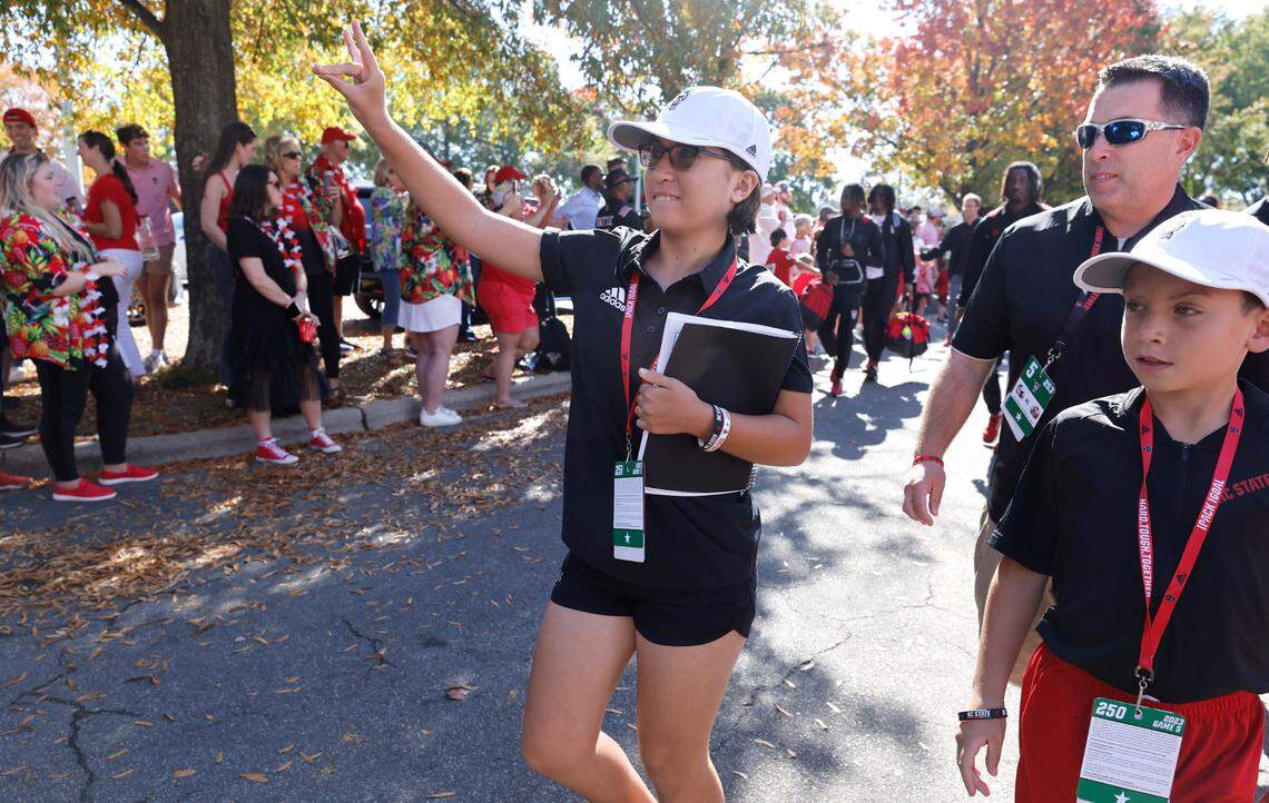 Payton Gibbs, 12, gives the Wolfpack sign during the Walk of Champions before N.C. State’s game against Clemson at Carter-Finley Stadium in Raleigh, N.C., Saturday, Oct. 28, 2023.