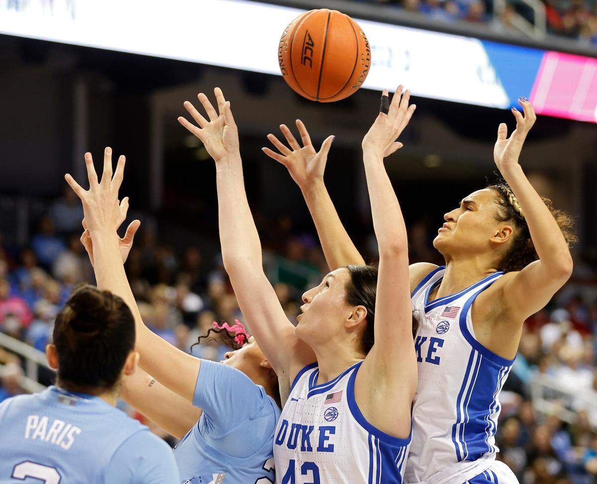 North Carolina’s Destiny Adams vies for a rebound with Duke’s Mia Heide and Celeste Taylor during the second half of the Blue Devils’ 44-40 win over North Carolina in an ACC Women’s Basketball Tournament quarterfinal game on Friday, March 3, 2023, at Greensboro Coliseum in Greensboro, N.C.