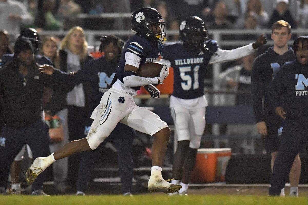Millbrook wide receiver Taden Martin (5) sprints for the long yardage against Jordan during the first half. The Millbrook Wildcats and the Jordan Falcons met in the third round of the NCHSAA 8A football playoffs in Raleigh, N.C. on November 21, 2025. 