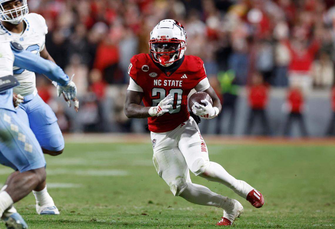 N.C. State running back Kendrick Raphael (20) gains yards during the first half of N.C. State’s game against UNC at Carter-Finley Stadium in Raleigh, N.C., Saturday, Nov. 25, 2023.