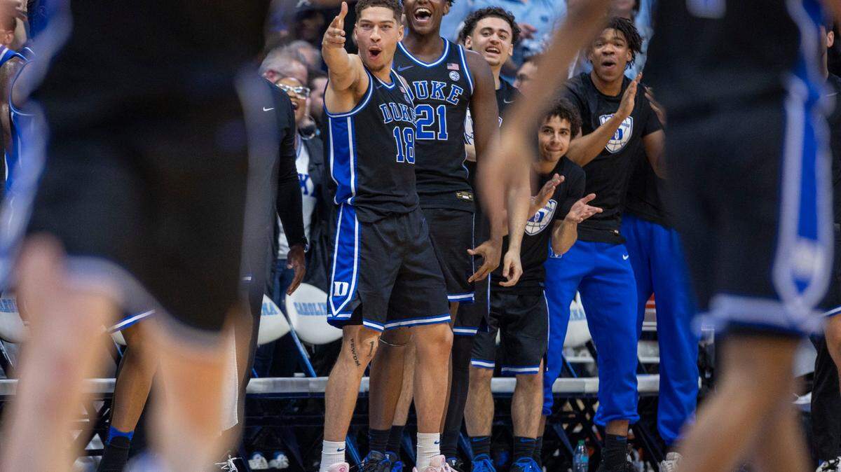 Duke’s Mason Gillis (18) and the Blue Devils bench react after teammate Maliq Brown (6) sank a three point basket in the second half against North Carolina on Saturday, March 8, 2025 at the Smith Center in Chapel Hill, N.C.