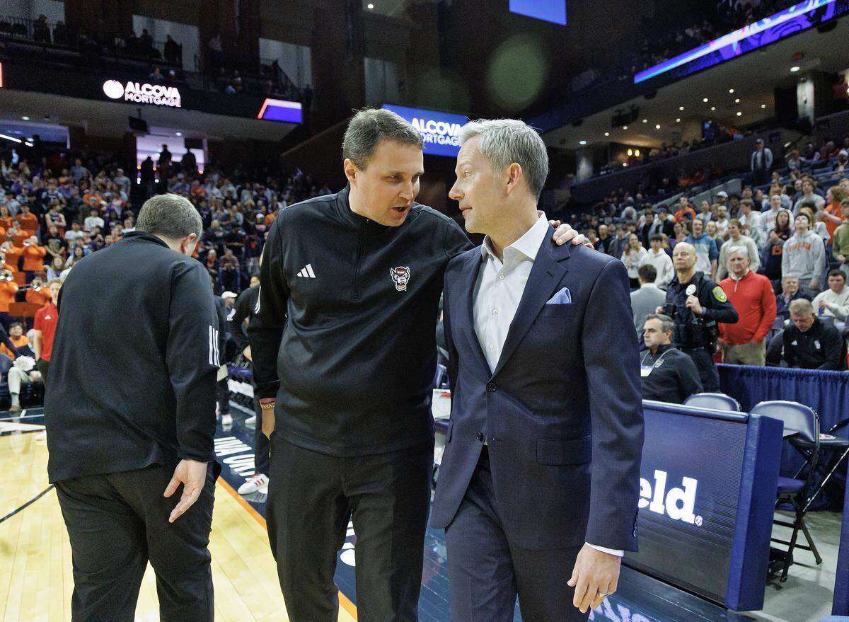 N.C. State head coach Will Wade talks with Virginia head coach Ryan Odom prior to their teams’ matchup on Thursday, Feb. 24, 2026, at John Paul Jones Arena in Charlottesville, Va. 