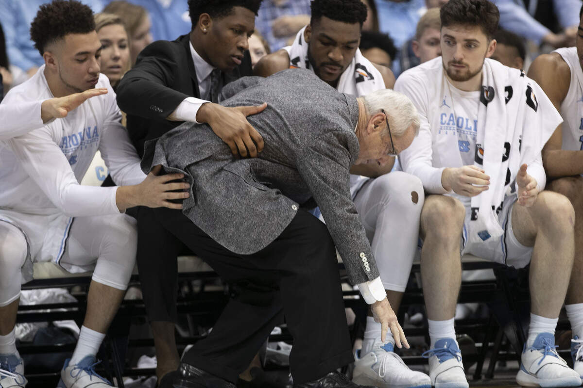 North Carolina coach Roy Williams collects himself with the help of the players on the bench during the second half against Louisville on Saturday, January 12, 2019 at the Smith Center in Chapel Hill, N.C. Williams was handed his worse home loss in 16 seasons at North Carolina, a 21 point defeat by Louisville.