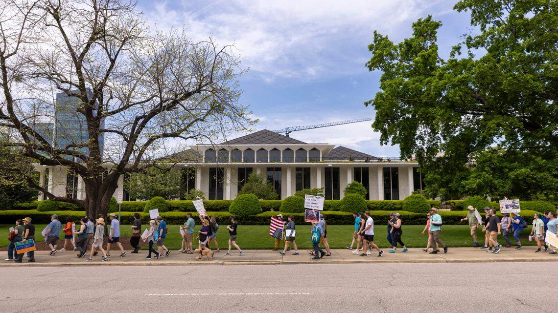 More than 1,000 demonstrators march around the Legislative Building after rallying on Halifax Mall in Raleigh to protest Trump administration policies on Saturday, April 19, 2025.