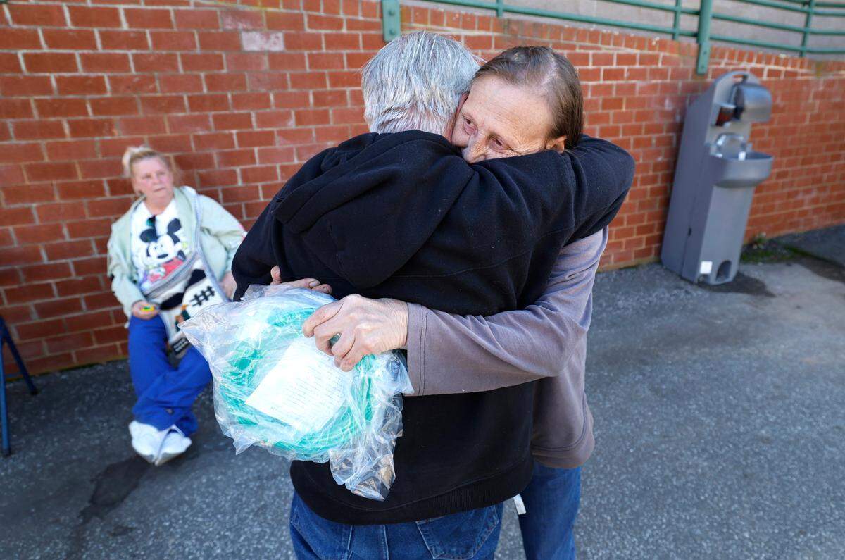 Joyce Lyons gets a hug from Pastor Brent Price outside the Red Cross shelter in Newland, N.C., on Thursday, Oct. 10, 2024. Joyce and her husband Davids’s mobile home on the Elk River, which they lived in since 1992, was engulfed by flood waters and floated away after Hurricane Helene passed the area. They have been living in the shelter until they can find temporary housing.