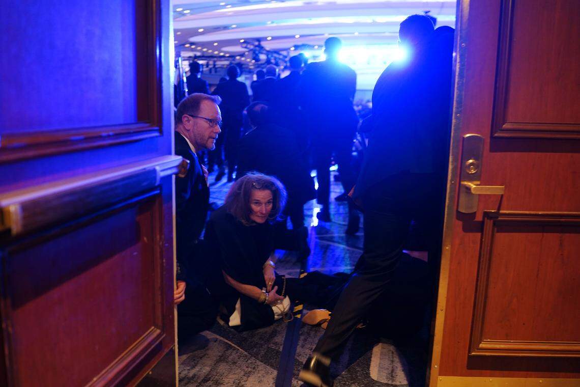 People take cover after an incident at the annual White House Correspondents Association Dinner April 25, 2026 in Washington, DC. According to reports, President Donald Trump, along with other government officials, were evacuated from the Washington Hilton after what sounded like gun fire. 