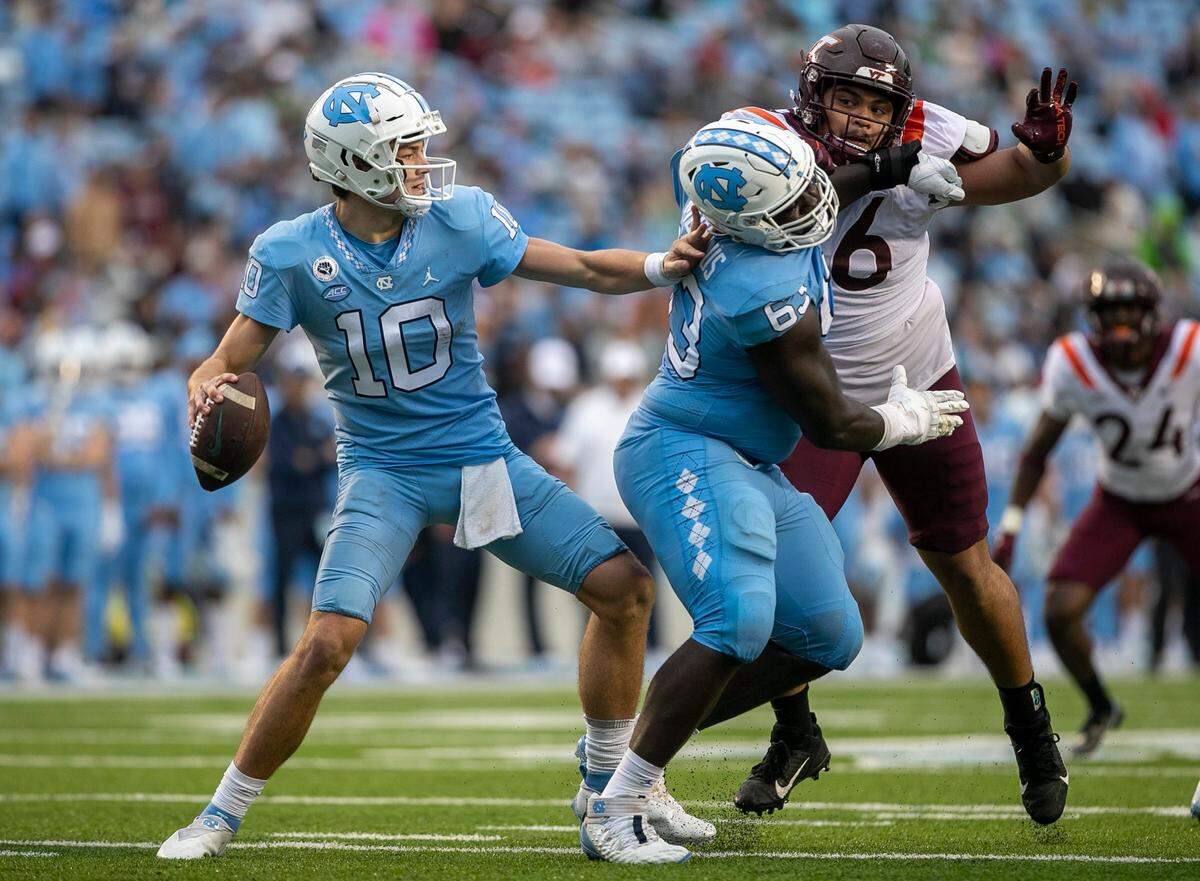 North Carolina lineman Ed Montilus (63) protects quarterback Drake Maye from Virginia Tech’s Josh Fuga (6) in the third quarter on Saturday, October 1, 2022 at Kenan Stadium in Chapel Hill, N.C. Maye threw for 363 yards and three touchdown in their 41-10 victory.