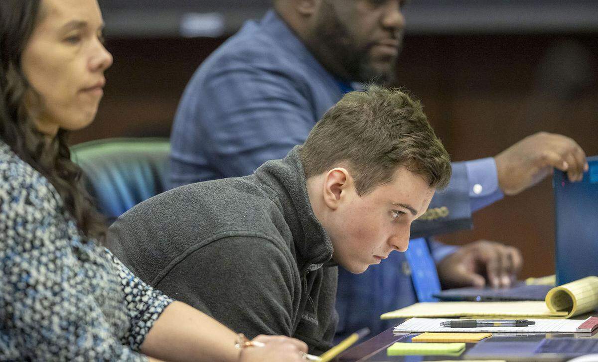 Austin Thompson takes a seat with his attorneys in Wake County Superior Court for his sentencing on Wednesday. Thompson pleaded guilty to murder in the 2022 Hedingham neighborhood mass shooting. 