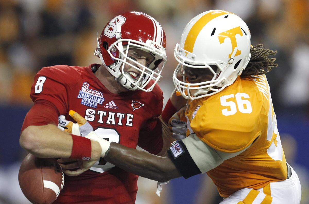 Tennessee’s Curt Maggitt (56) strips the ball from N.C. State’s Mike Glennon (8) causing a safety during the first half of N.C. State’s game against Tennessee in the Chick-fil-A Kickoff Game Friday, August 31, 2012, at the Georgia Dome in Atlanta, GA.