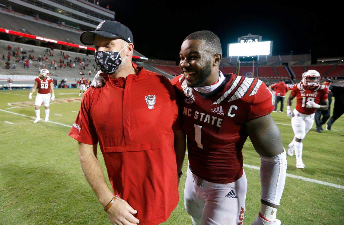 N.C. State linebacker Isaiah Moore (1) celebrates with head coach Dave Doeren after N.C. State’s 45-42 victory over Wake Forest at Carter-Finley Stadium in Raleigh, N.C, Saturday, Sept. 19, 2020.