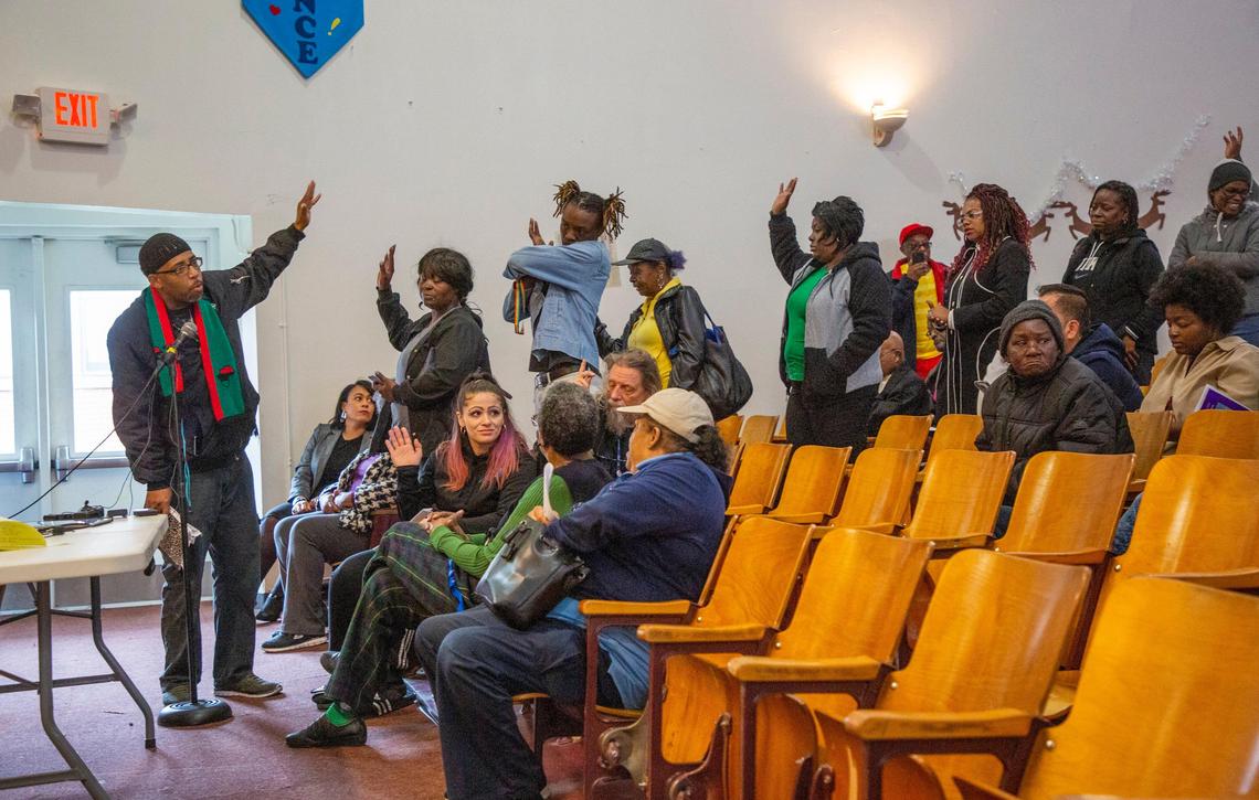 Minister Paul Scott asks the crowd who had mold in their apartments during a community meeting held after seven carbon monoxide poisonings were reported at McDougald Terrace within in 30 days and two infant deaths reported, which were unrelated to the carbon monoxide according to the Durham Fire Department, at Burton Elementary School on Thursday, Jan. 2, 2020, in Durham, NC.