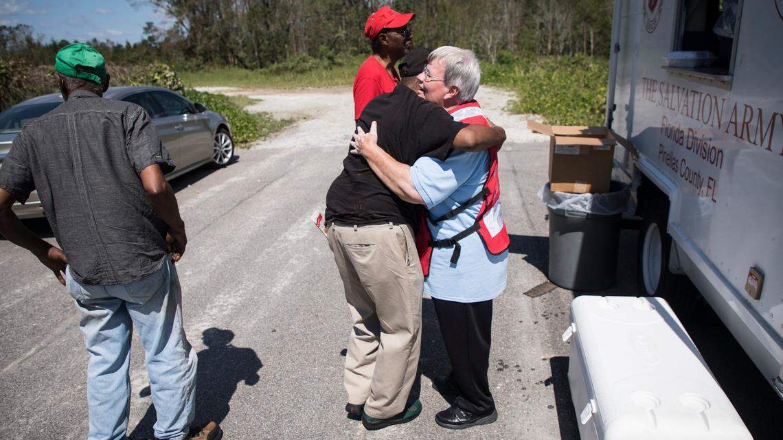 Marvis Steele, a Salvation Army employee from Lubbock, Texas, receives a hug after passing out free meals in a Wilmington neighborhood on Wednesday, Sept. 19, 2018. Operation BBQ Relief sends out food with groups like the Salvation Army to neighborhoods across the city for both lunch and dinner.