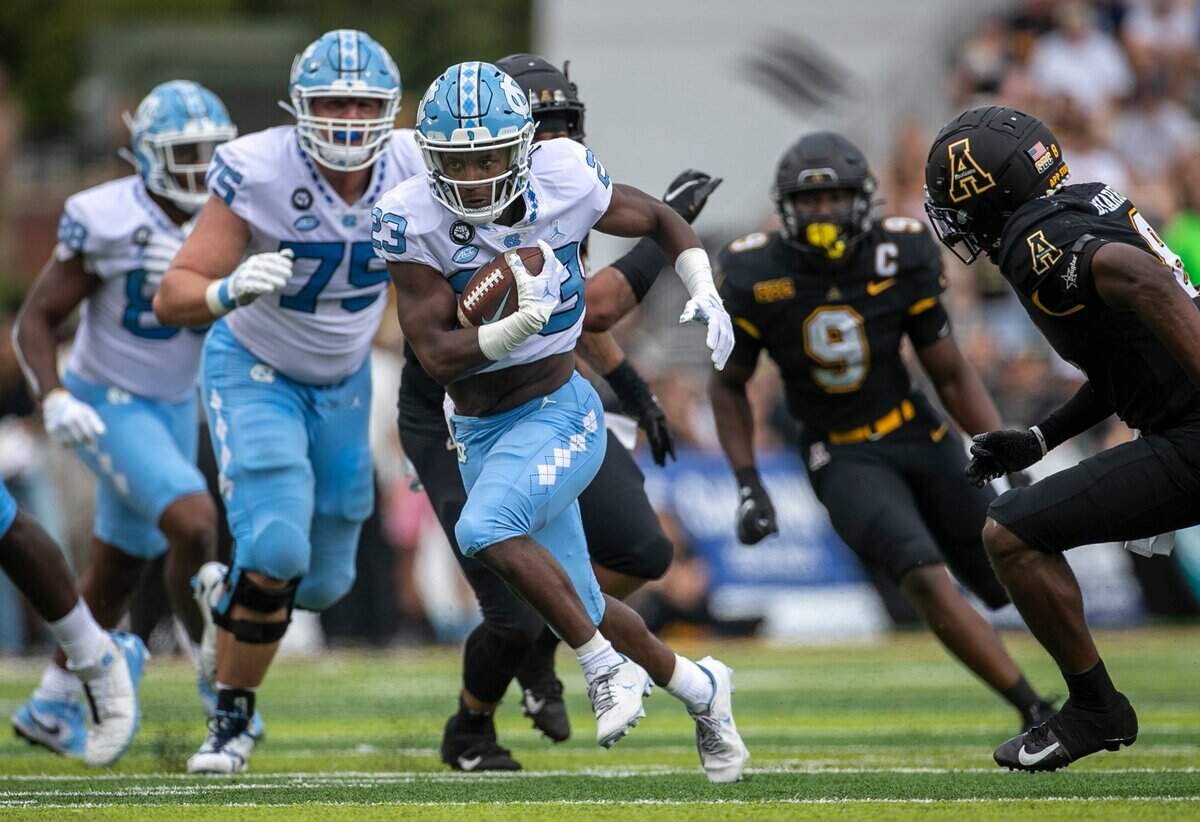 North Carolinas George Pettaway (23) races for a 11-yard gain in the second quarter against Appalachian State on Saturday, September 3, 2022 at Kidd Brewer Stadium in Boone, N.C.