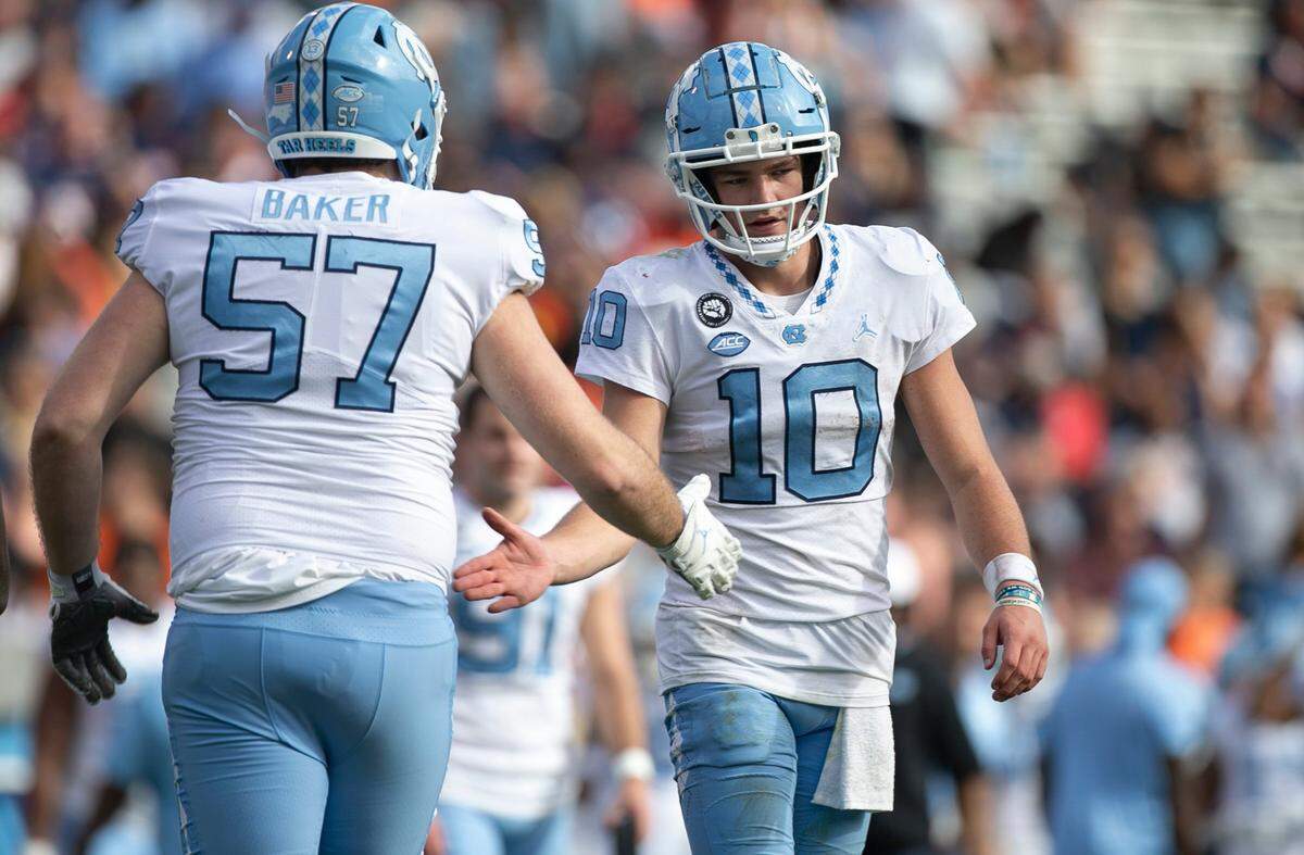 North Carolina quarterback Drake Maye (10) congratulates lineman Cayden Baker (57) after scoring in the fourth quarter against Virginia on Saturday, November 5, 2022 at Scott Stadium in Charlottesville, Va.