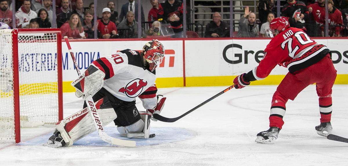 The New Jersey Devils goalie Akira Schmid (40) stops a scoring attempt by the Carolina Hurricanes Sebastian Aho (20) in the first period during Game 1 of their second round Stanley Cup playoff series on Wednesday, May 3, 2023 at PNC Arena in Raleigh, N.C.