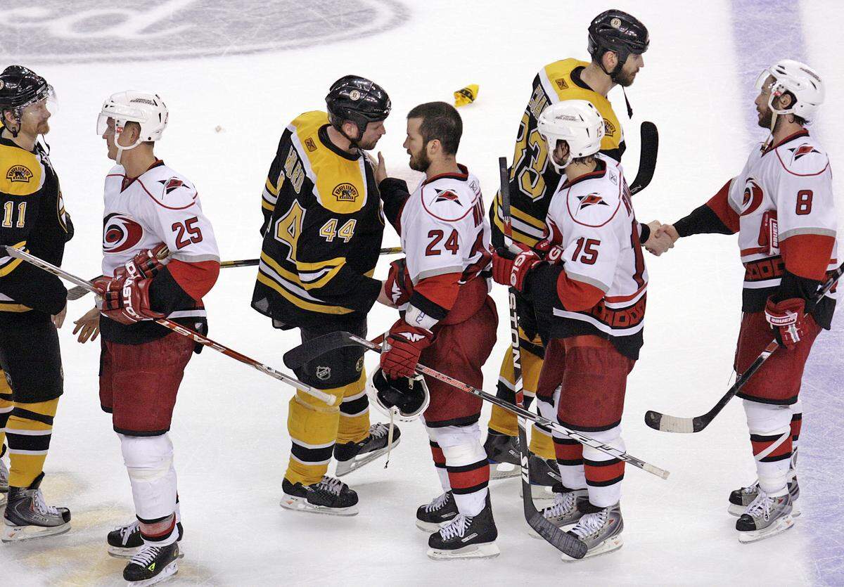 The Carolina Hurricanes’ Scott Walker (24) shakes hands with the Boston Bruins’ Aaron Ward (44) at the conclusion of Game 7 of an NHL playoff between the Carolina Hurricanes and the Boston Bruins at the TD Banknorth Garden in Boston, Thursday May 14, 2009. The Canes beat the Bruins 3-2 in overtime to advance to the Eastern Conference finals in the Stanley Cup playoffs.