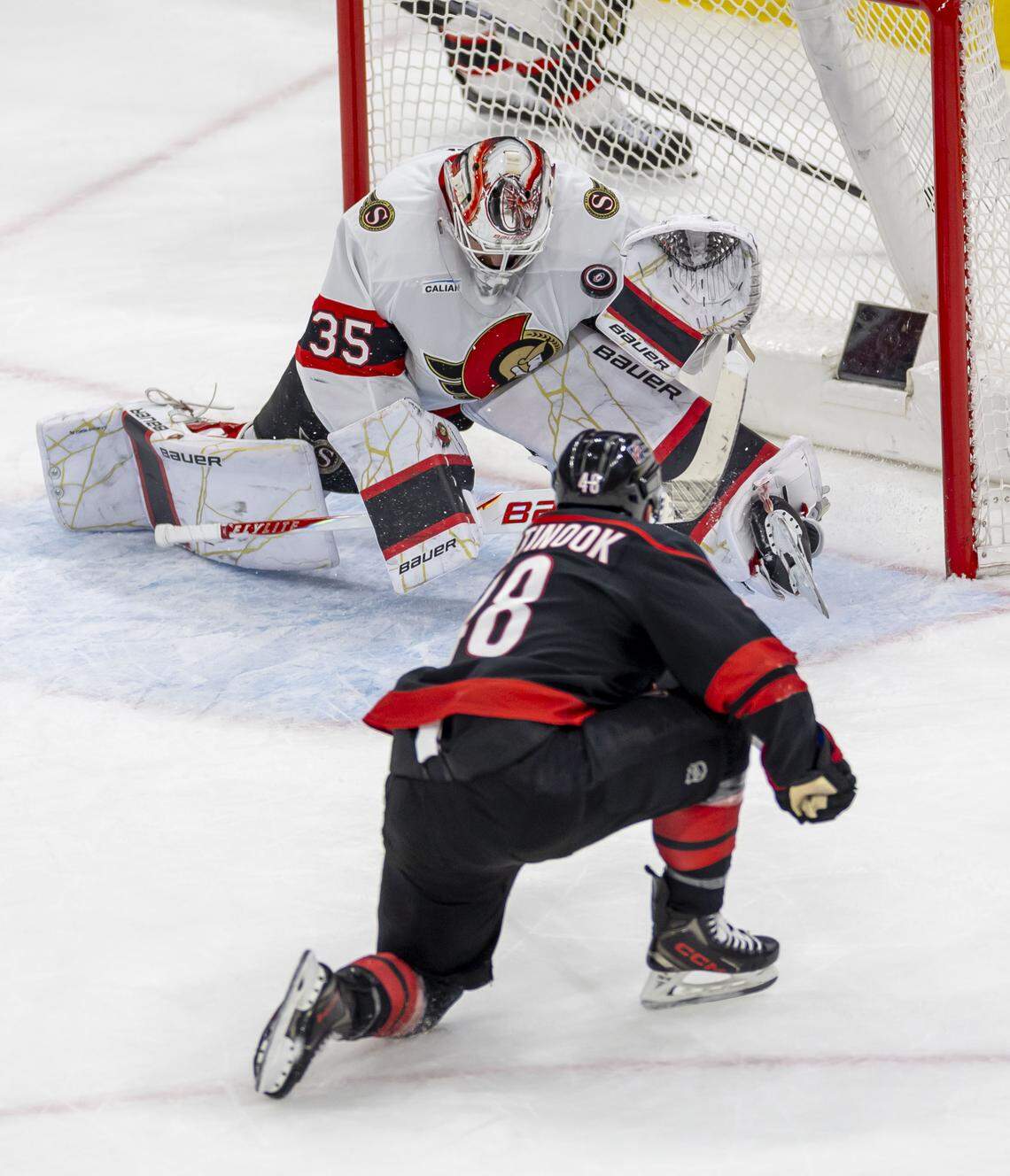 Ottawa Senators goalie Linus Ullmark (35) stops a scoring attempt by Carolina Hurricanes left wing Jordan Martinook (48) in the second period of Game 2 on Monday, April 20, 2026 during the first round of the Stanley Cup Playoffs at Lenovo Center in Raleigh, N.C.