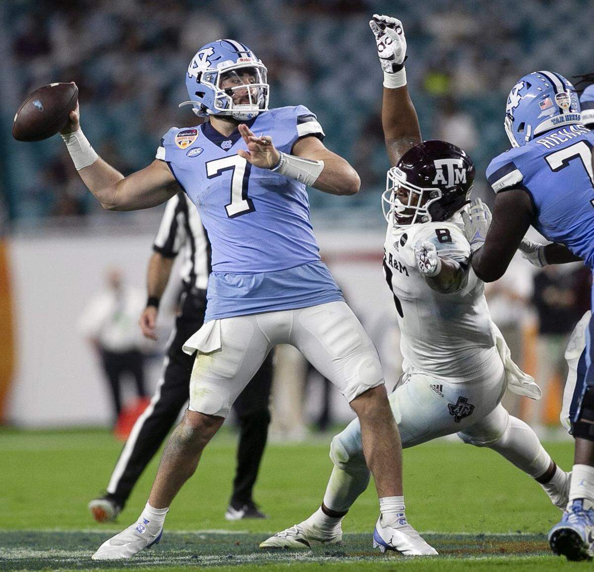 Texas A&M’s DeMarvin Leal (8) pressures North Carolina quarterback Sam Howell in the third quarter during the Capital One Orange Bowl on Saturday, January 2, 2021in Miami Gardens, Florida. 