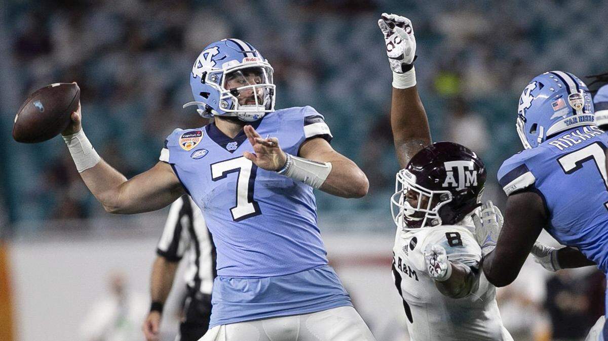 Texas A&M’s DeMarvin Leal (8) pressures North Carolina quarterback Sam Howell in the third quarter during the Capital One Orange Bowl on Saturday, January 2, 2021in Miami Gardens, Florida.