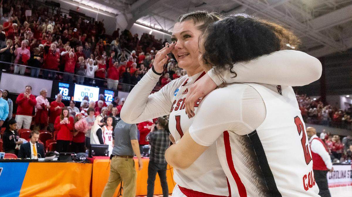 NC State’s River Baldwin (1) wipes a tear as Baldwin and and Mimi Collins (2) celebrate the Wolfpack’s 79- 72 win over Tennessee in the second round of the Division I Women’s Basketball Championship at Reynolds Coliseum in Raleigh, on March 25, 2024.