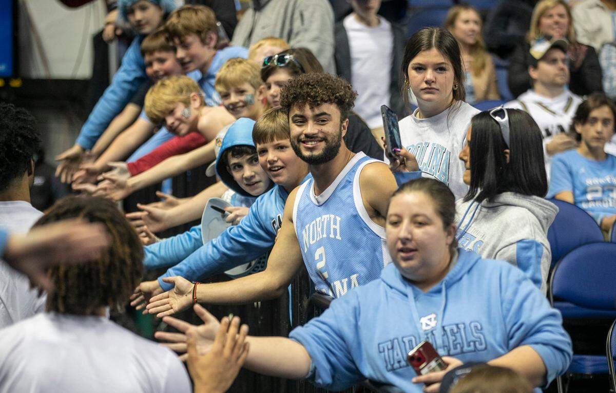 North Carolina fans greet the Tar Heels as they leave the court after their pre-game warm up prior to their game against Boston College in the second round of the ACC Tournament on Wednesday, March 8, 2023 at the Greensboro Coliseum in Greensboro, N.C.