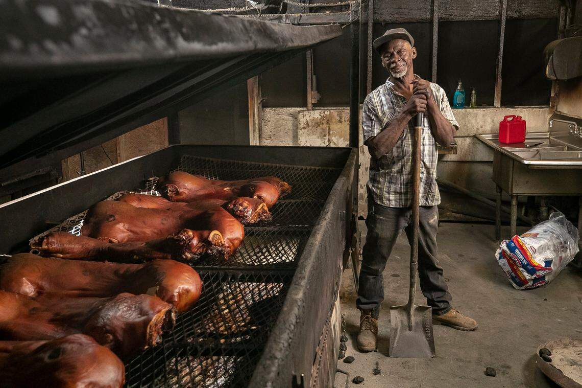 Just before 2 a.m., Bs Barbecue pit master Ronald House, aka Time, shows off the golden brown hogs before the final firing to complete cooking on Friday, June 10, 2022 in Greenville, N.C.