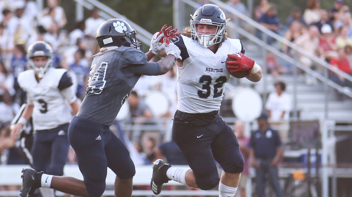 Heritage running back Drake Thomas (32) stiff-arms Millbrook linebacker Marcellus Davis (54). The Heritage Huskies defeated the Millbrook Wildcats 35-21 on Friday, August 31, 2018.