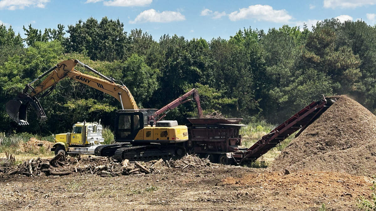 A backhoe scoops up debris from area being cleared on the Dix Park property, Wednesday, June 17, 2026.