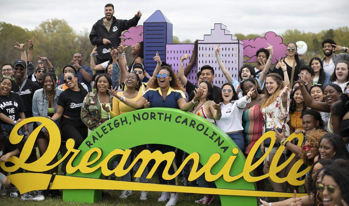 Music fans line up for a group photo with the Dreamville logo on Saturday, April 6, 2019 at the Dreamville Festival at Dix Park in Raleigh, N.C. The inaugural event, the brainchild of artist J. Cole, drew thousands of music fans to the day long event at Dix Park.