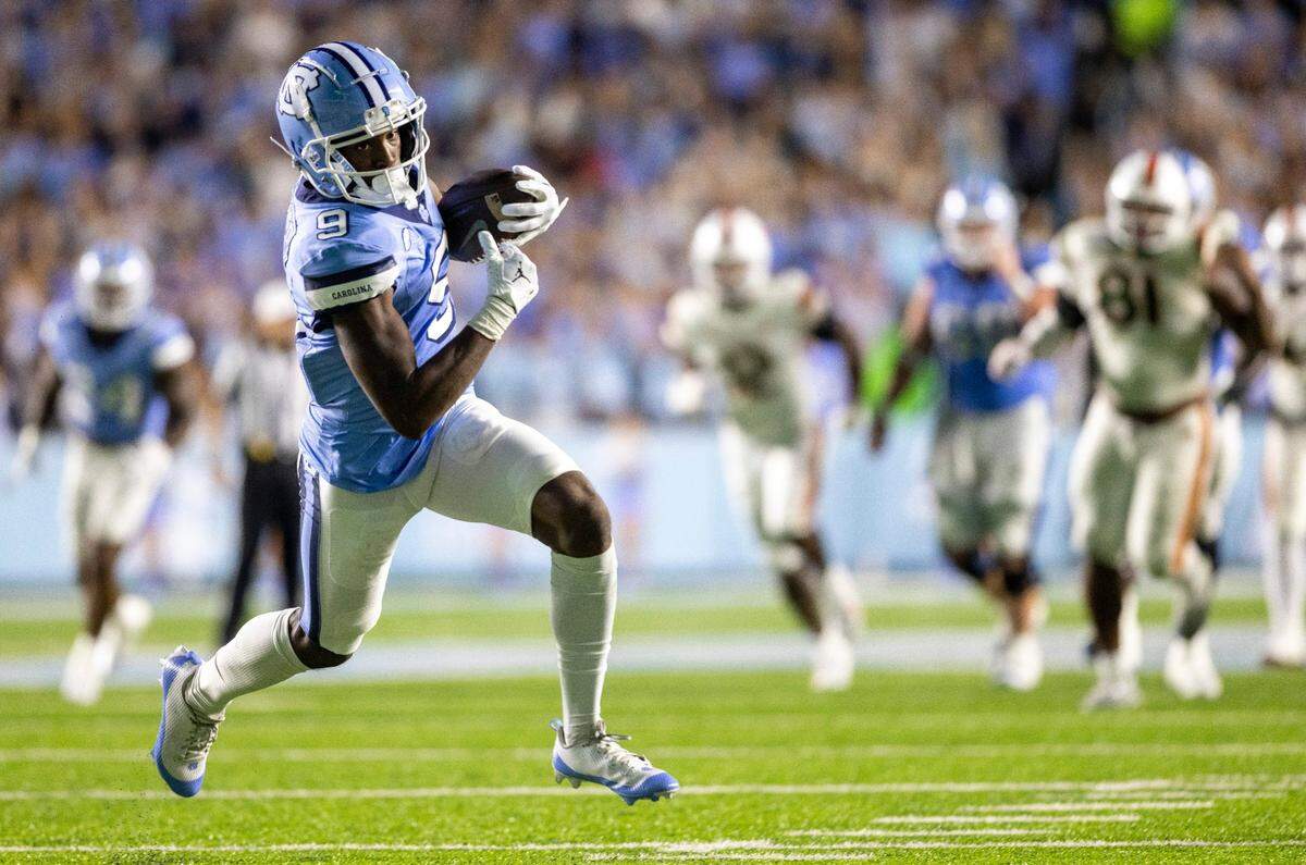 North Carolina wide receiver Devontez Walker (9) scores on an 33-yard pass completion from quarterback Drake Maye to give the Tar Heels a 28-17 lead in the third quarter against Miami on Saturday, October 14, 2023 at Kenan Stadium in Chapel Hill, N.C.