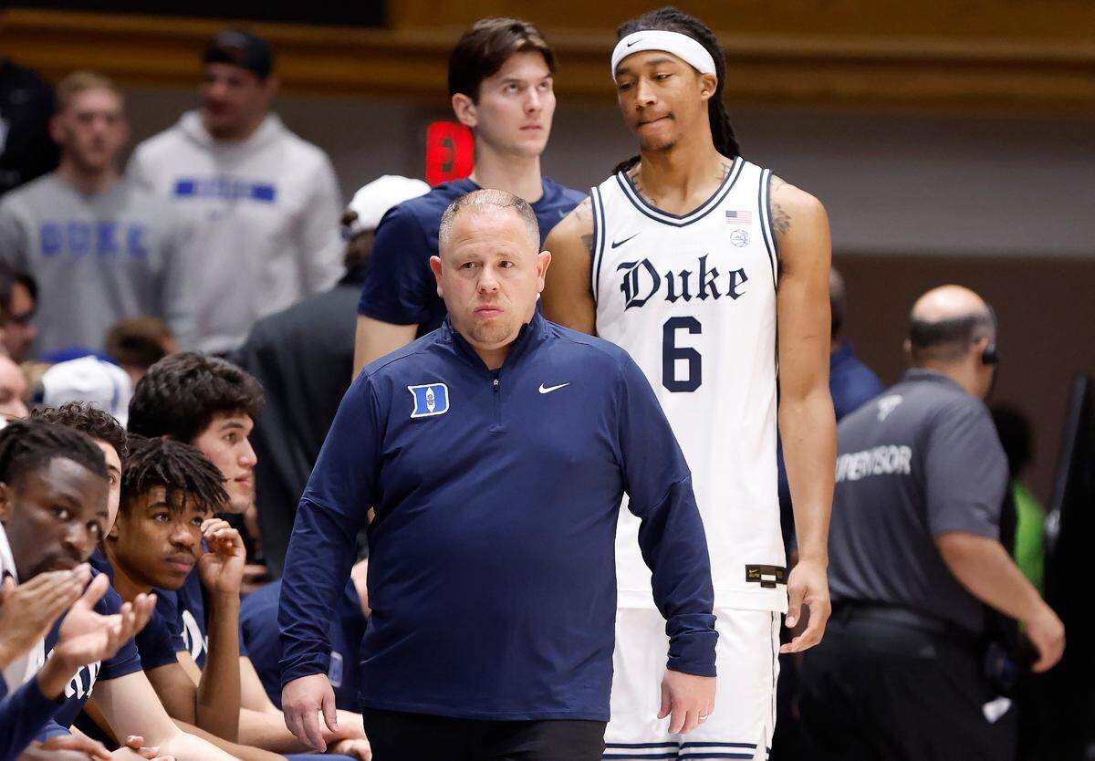 Duke’s Maliq Brown (6) walks back to the bench with Jose Fonseca, head men’s basketball trainer, during the first half of Duke’s game against Notre Dame at Cameron Indoor Stadium in Durham, N.C., Saturday, Jan. 11, 2025. Brown would not return to the game.