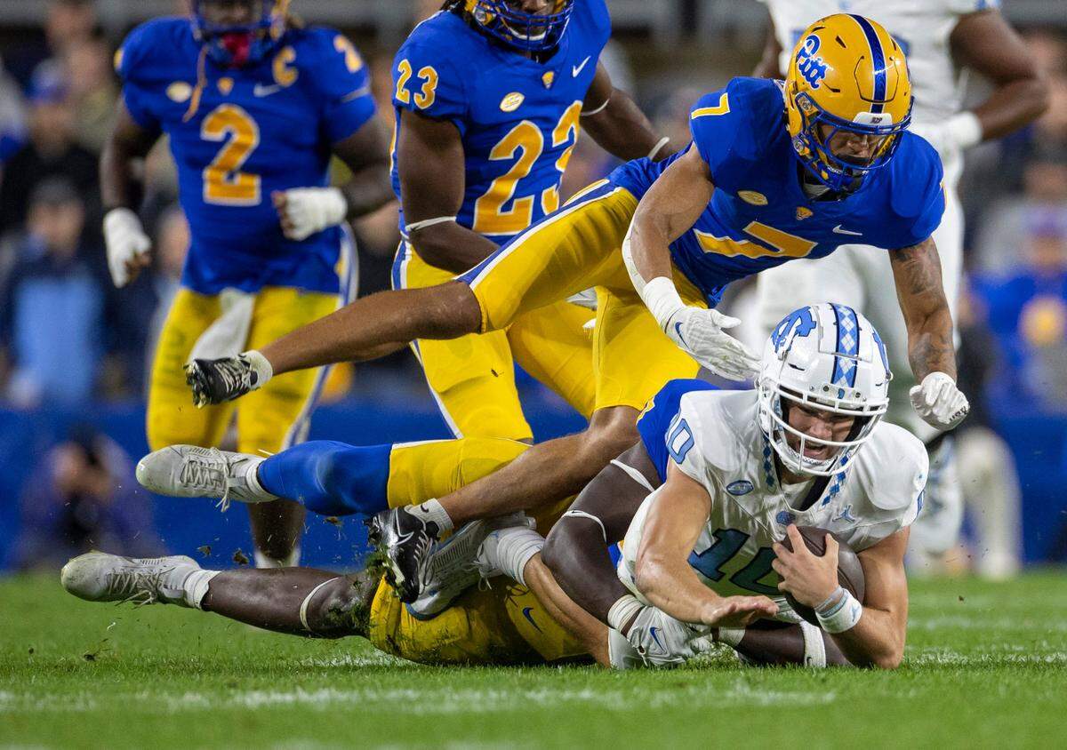North Carolina quarterback Drake Maye (10) is sacked for a loss of two yards by Pitt’s David Green in the first quarter on Saturday, September 23, 2023 at Acrisure Stadium in Pittsburgh, Pa.