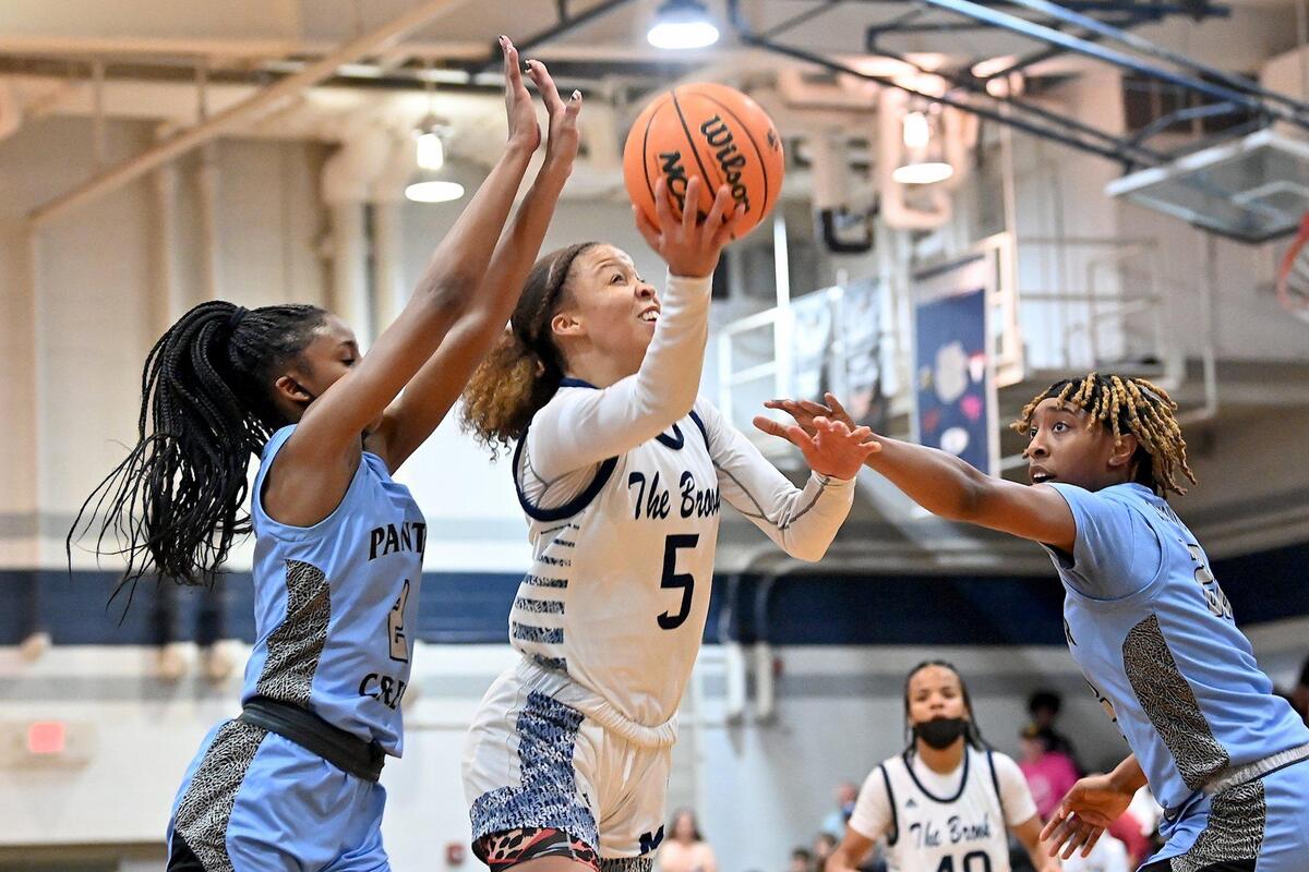 Millbrook’s Reychel Douglas (5) attempts the shot against the Panther Creek’s Taylor Barner (2) and Elisha Aull (23) in the first half. The Millbrook Wildcats and the Panther Creek Catamounts met in a NCHSAA 4A fourth round game in Raleigh, N.C. on March 1, 2022.