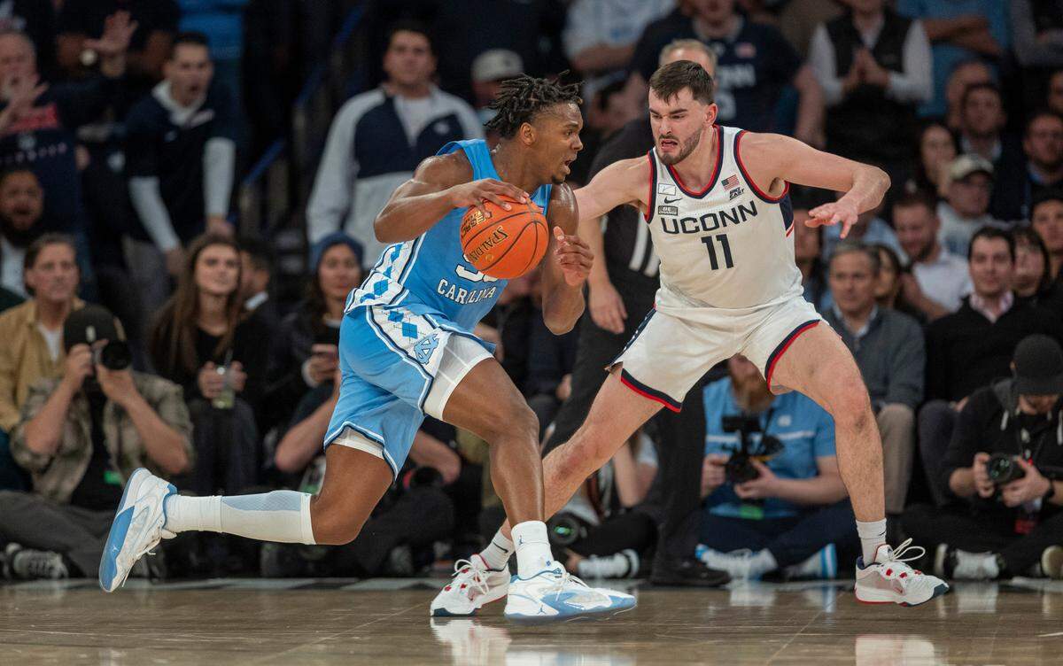 North Carolina’s Harrison Ingram (55) drives against Connecticut’s Alex Karaban (11) during the first half in the Jimmy V Classic on Tuesday, December 5, 2023 at Madison Square Garden in New York, NY.