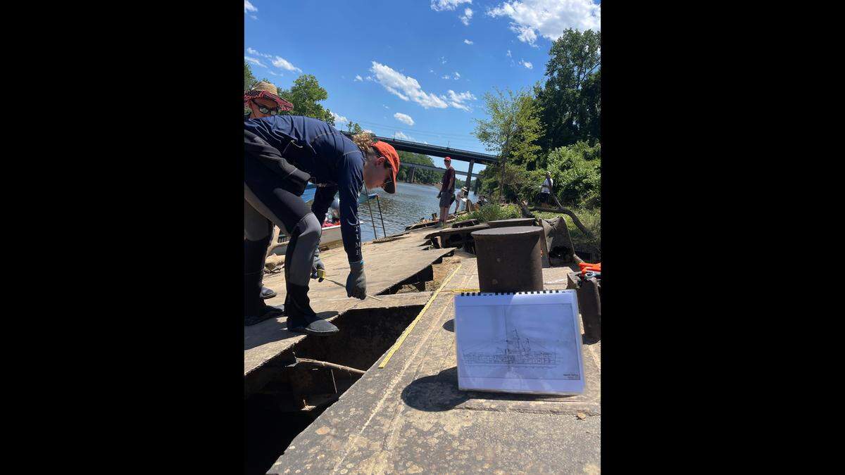 Researcher Krysta Rogers records areas that have been salvaged on the wreck of the PC-1084 subchaser in the Cape Fear River near Fayetteville.