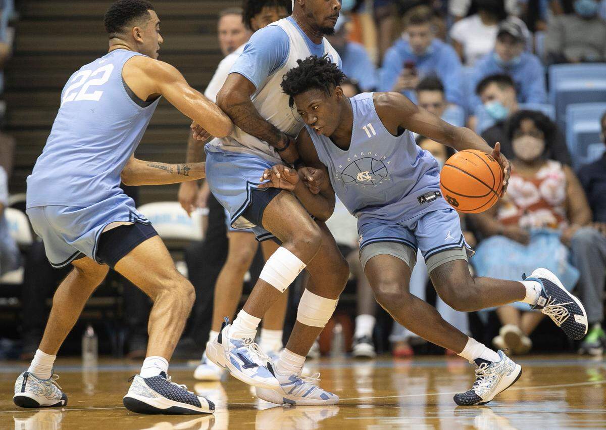 North Carolina’s D’Marco Dunn (11) drives against Anthony Harris (0) during a scrimmage at Late Night on Friday, October 15, 2021 at the Smith Center in Chapel Hill, N.C.
