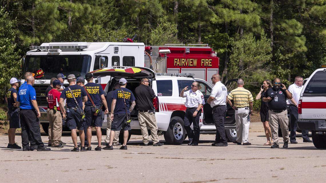 Emergency personnel stage a search from the parking lot of West Lake Middle School in Apex Friday, July 29, 2022. A twin-engine turboprop aircraft made an emergency landing Friday at RDU after reported landing gear issues. Another pilot reportedly jumped out of the plane toward a body of water near West Lake Middle School in Apex before the landing attempt.