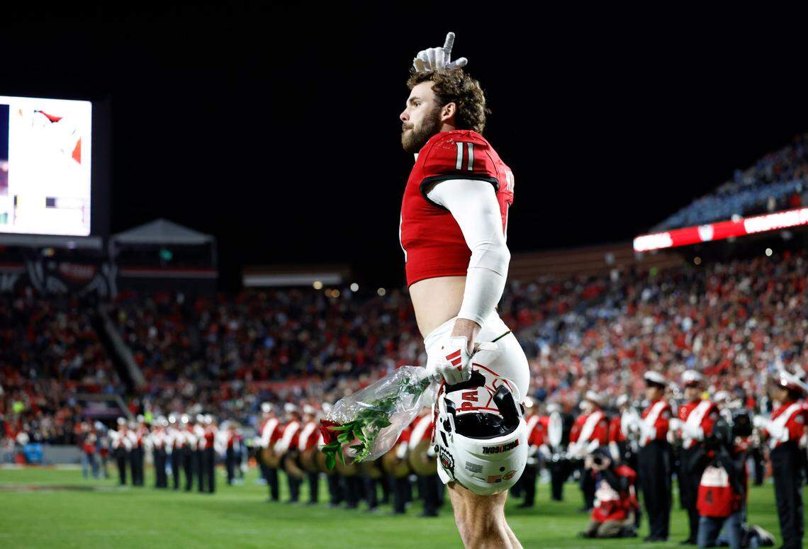 N.C. State linebacker Payton Wilson (11) acknowledges the crowd after he was introduced on senior day before the Wolfpack’s game against UNC at Carter-Finley Stadium in Raleigh, N.C., Saturday, Nov. 25, 2023.