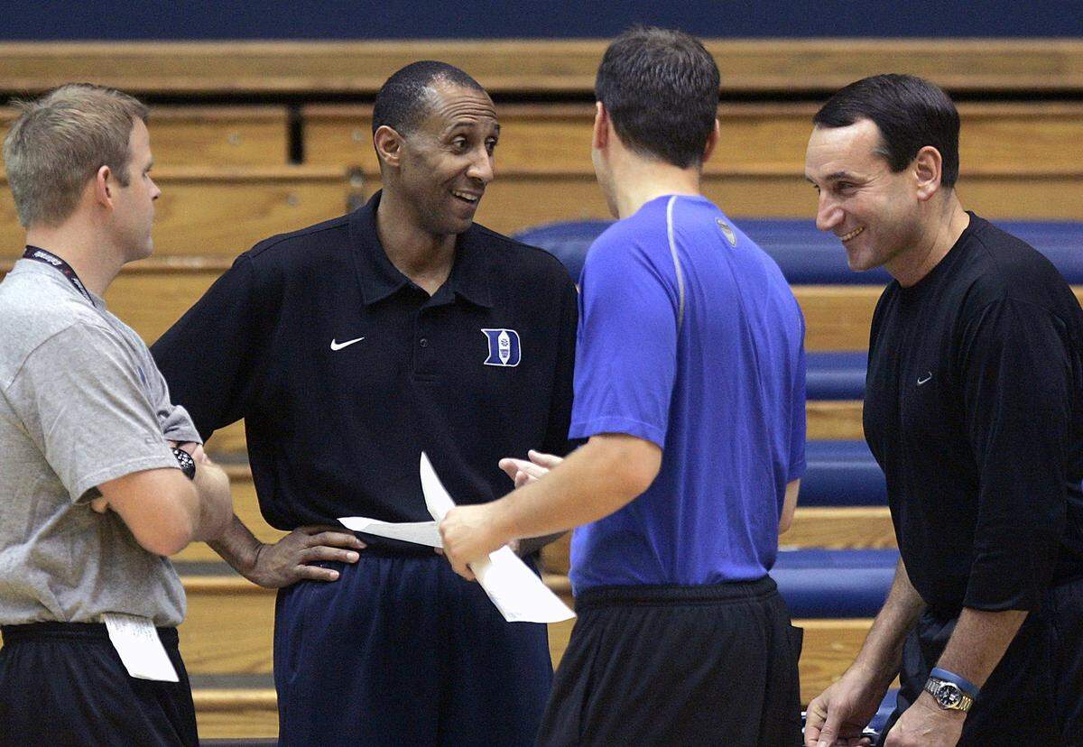 Duke men’s basketball coach Mike Krzyzewski, second from right, jokes with, from left, assistant Coach Steve Wojciechowski, associate head coach Johnny Dawkins, and assistant coach Chris Collins during practice at Cameron Indoor Stadium on Friday, Oct. 26, 2007.