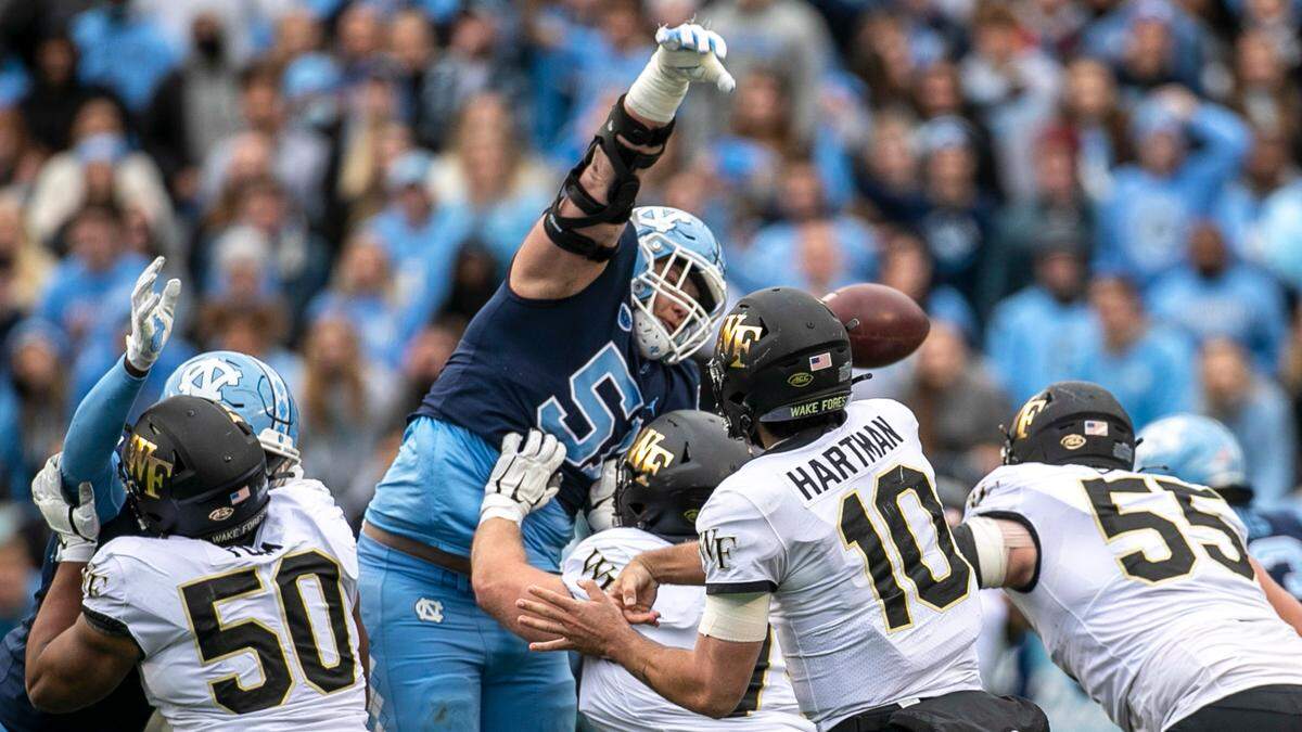 North Carolina’s Raymond Vohasek (51) deflects a pass by Wake Forest quarterback Sam Hartman (10) of fourth down, turning the ball over to the Tar Heels who scored the game winning field goal on Saturday, November 6, 2021 at Kenan Stadium in Chapel Hill, N.C.