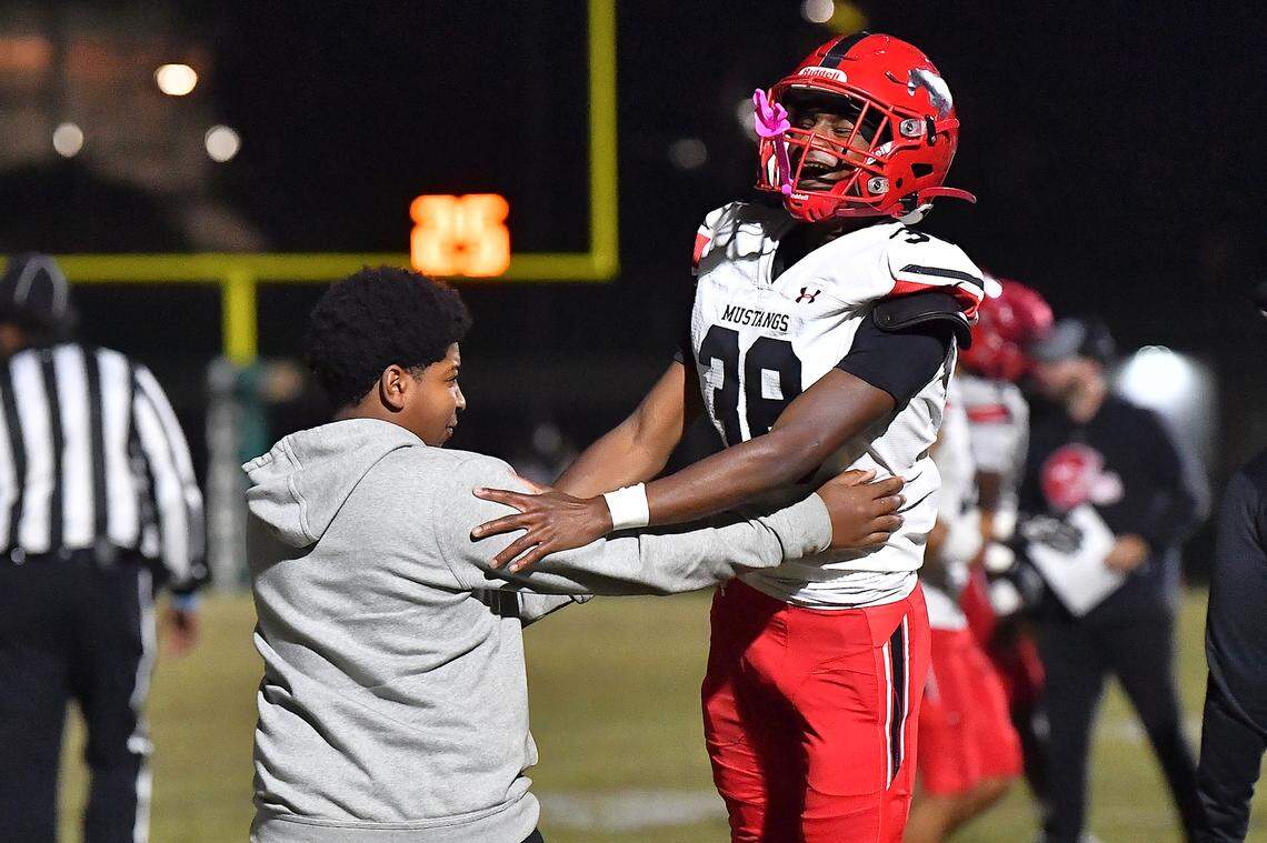 Middle Creek's EJ Alvardo (38) celebrates his team's touchdown against Cary with Kevin Moody during the first half. The Cary Imps and the Middle Creek Mustangs met in a conference football game in Cary, N.C. on October 24, 2025