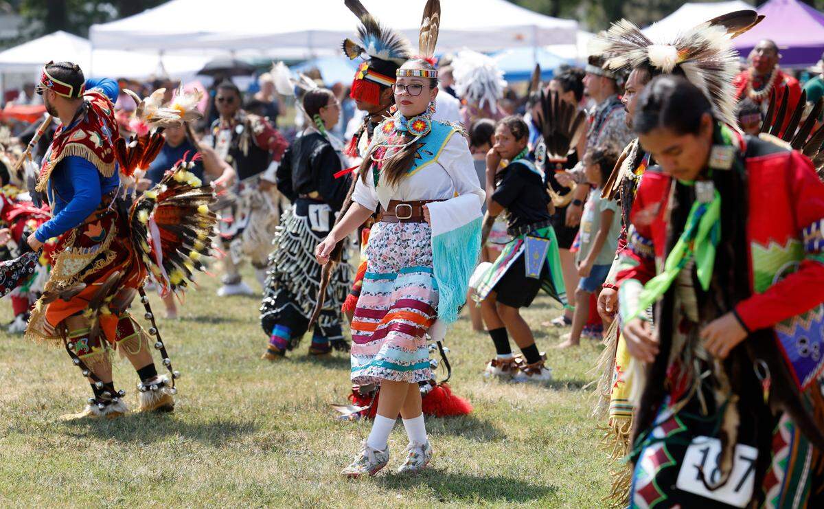 Attendees participate in a blanket dance during the Dix Park Inter-Tribal Pow Wow in Raleigh, N.C., Saturday, August 26, 2023.