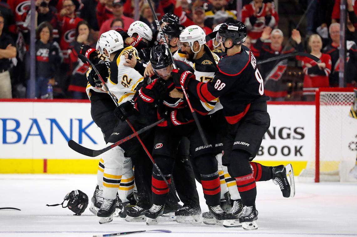Players skirmish after Game 2 of an NHL hockey Stanley Cup first-round playoff series between the Boston Bruins and the Carolina Hurricanes in Raleigh, N.C., Wednesday, May 4, 2022. (AP Photo/Karl B DeBlaker)