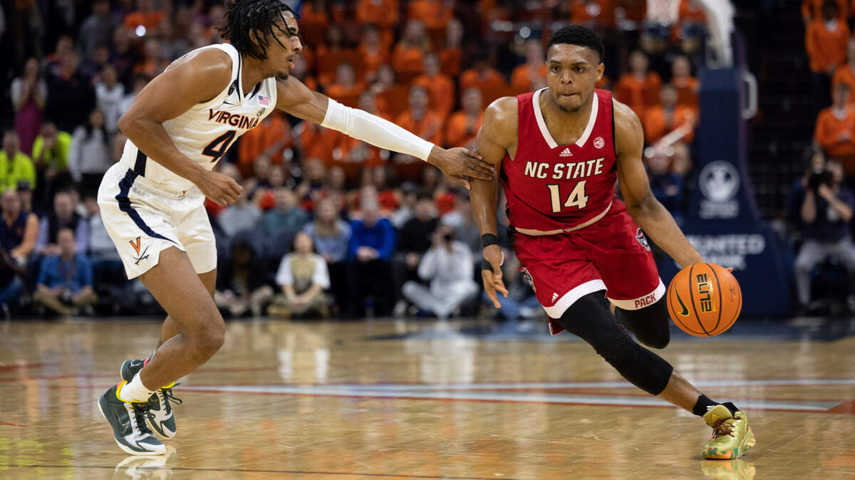 Virginia’s Armaan Franklin (4) defends against North Carolina State’s Casey Morsell (14) during the first half of an NCAA college basketball game in Charlottesville, Va., Tuesday, Feb. 7, 2023. (AP Photo/Mike Kropf)