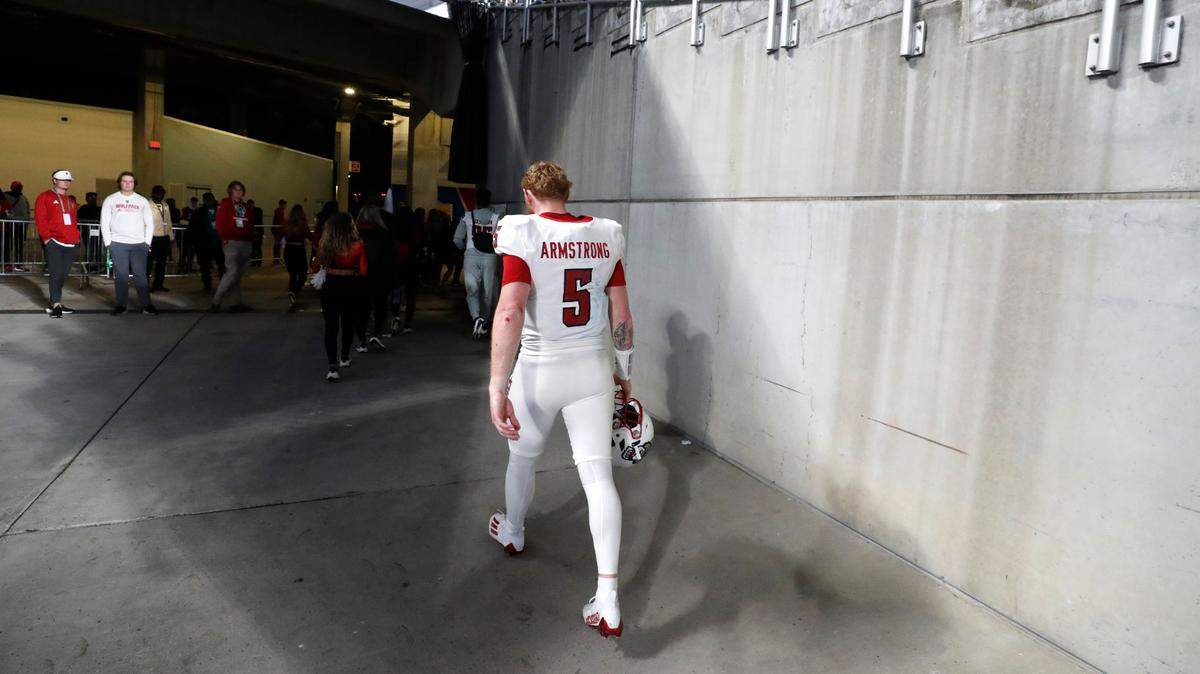 N.C. State quarterback Brennan Armstrong (5) walks off the field after Kansas State’s 28-19 victory over N.C. State in the Pop-Tarts Bowl at Camping World Stadium in Orlando, Fla., Thursday, Dec. 28, 2023.